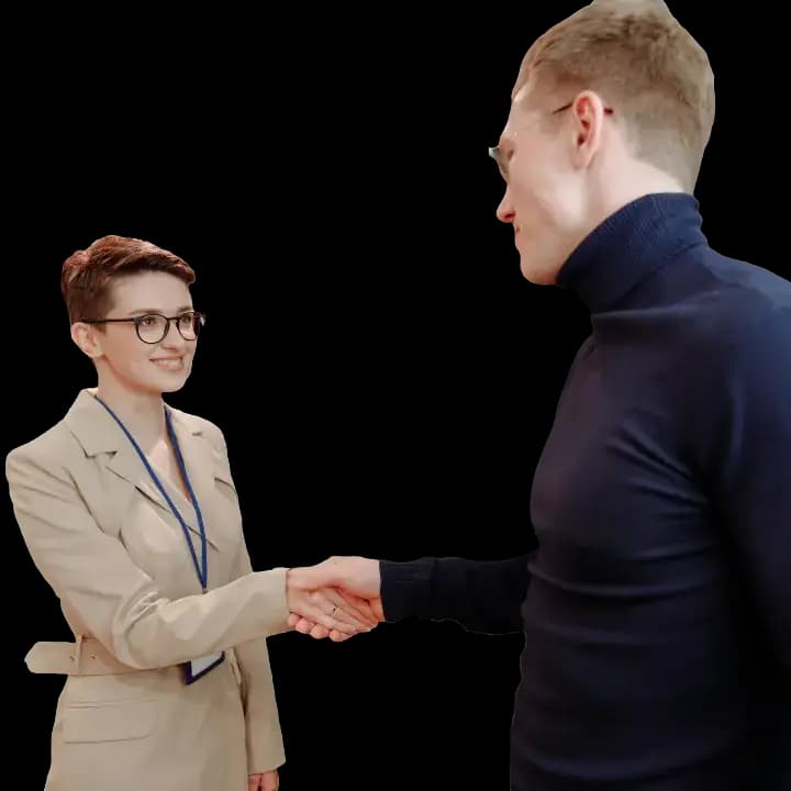 Two business partners shaking hands and smiling, symbolizing their successful partnership registration.