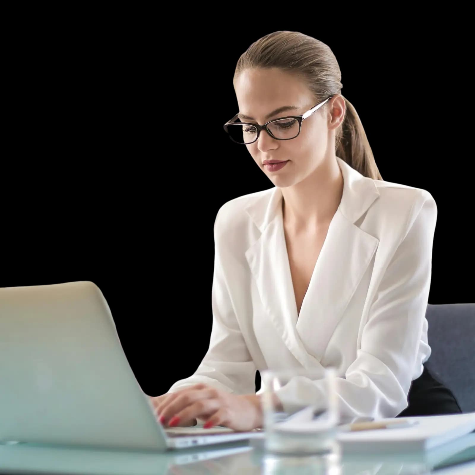 A business professional in formal attire sitting at a desk with a laptop, notebook, and glass of water—focused on reinstating a business online and ensuring compliance.
