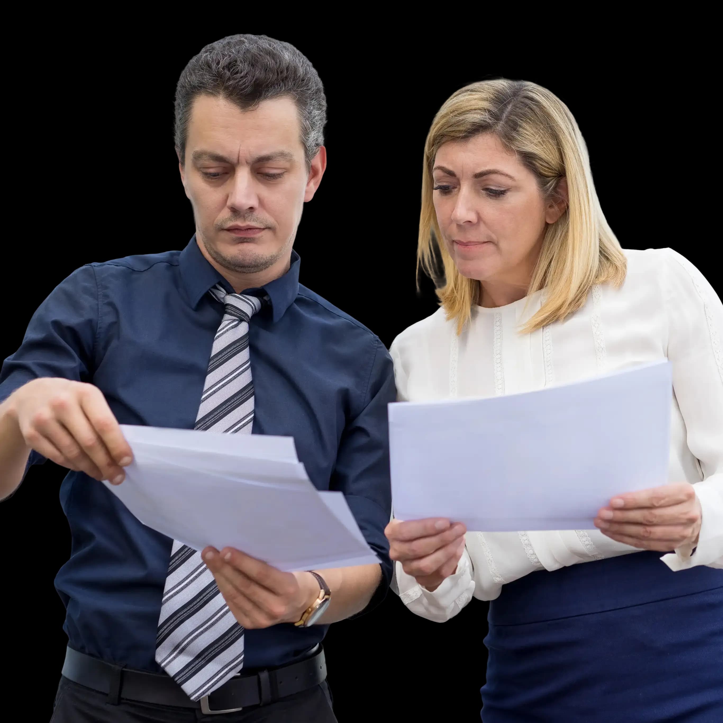 Two business professionals in formal attire reviewing documents together, both holding papers and collaborating—illustrating teamwork and accuracy in the LLC formation process.